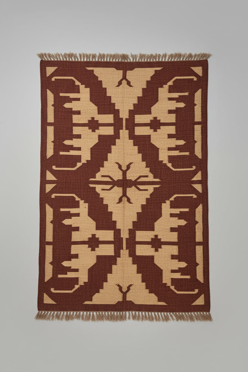 A large woven area rug with a geometric tribal pattern in dark brown and beige.