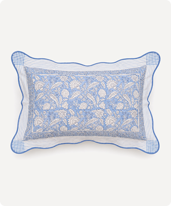 A rectangular decorative pillow with a blue and white floral paisley pattern, featuring a striped border and a blue gingham check edge, shown against a plain light background.