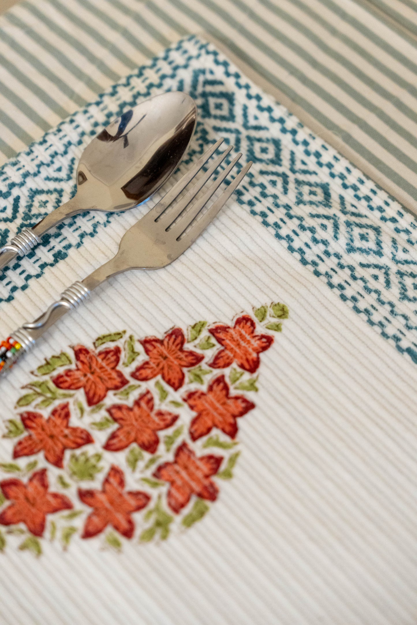 dining table placement mats in cotton in orange and green, hand block printed with chemical free dyes