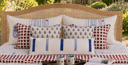 a striped and patterned hand block printed bedding set in red, white, and blue, decorative throw pillows and cushion covers